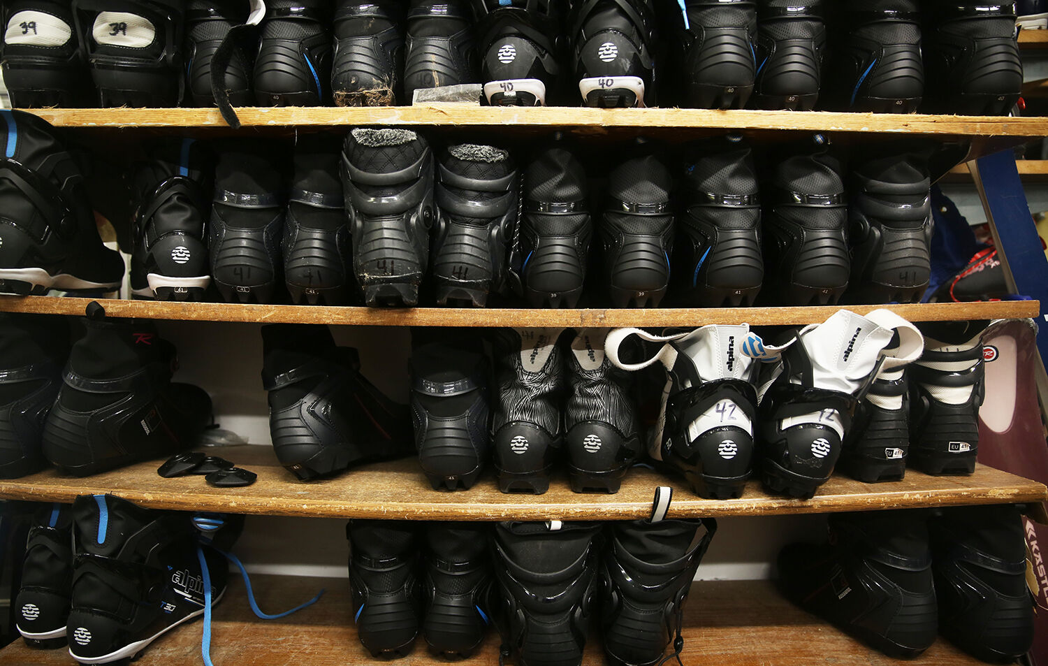 A shelf of boots holds guards one of the front two walls